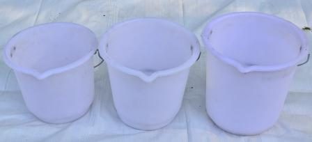 Three white Polycon moulded buckets with pouring spouts